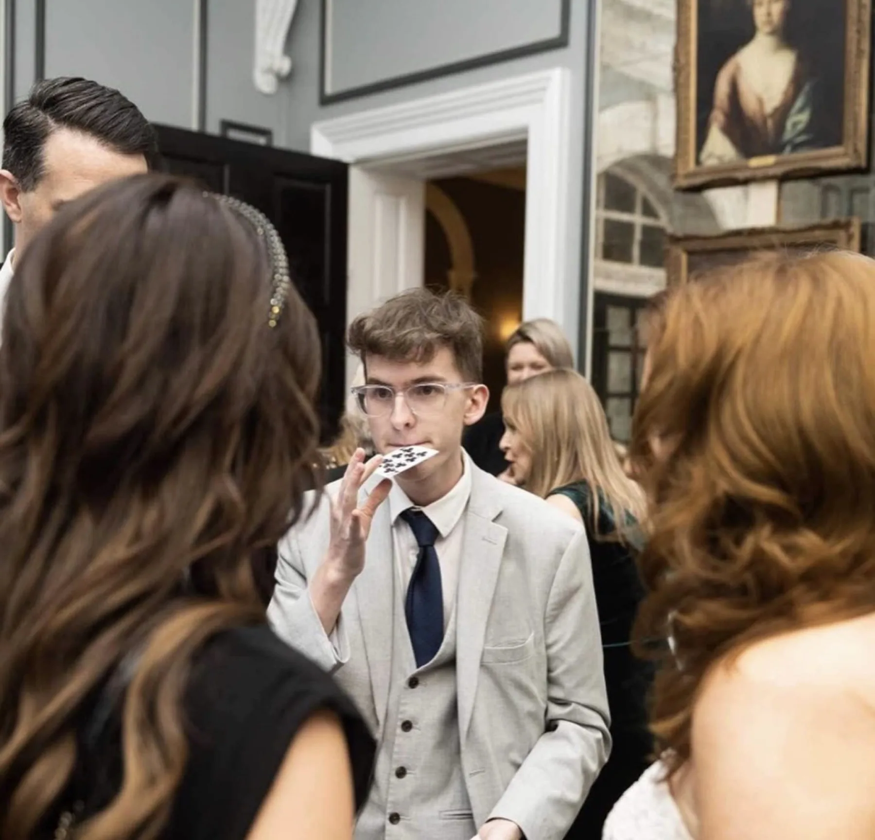 Harry Phillips performing close-up card magic for wedding guests